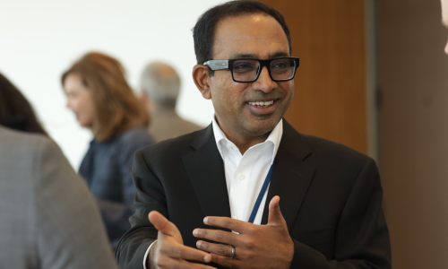 Attendee smiling beside a fellow guest during a 2025 symposium break