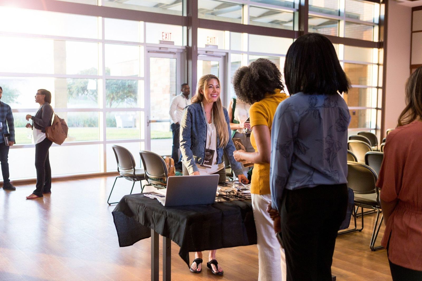 Attendees mingling near a sponsor display table