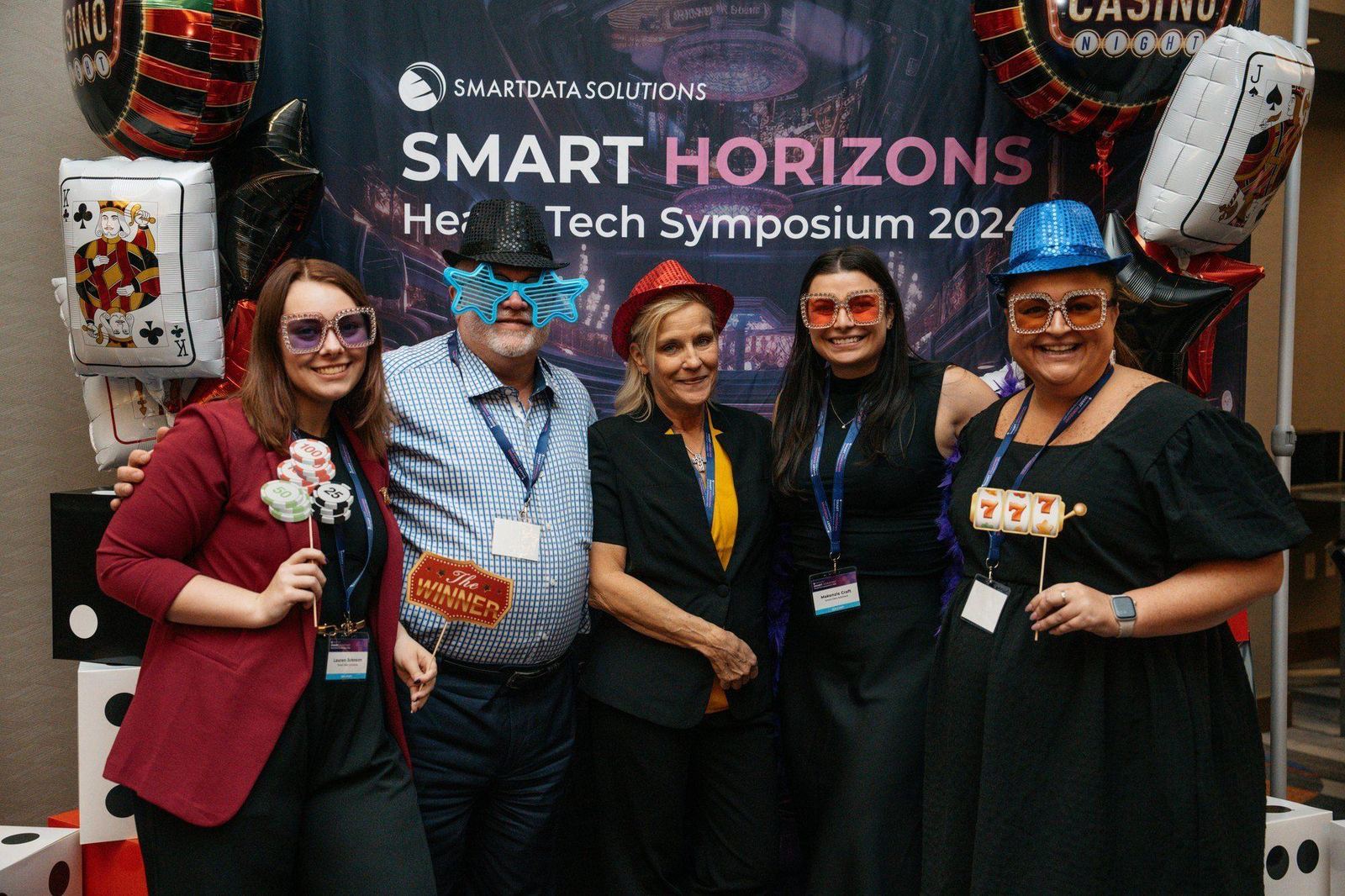 Attendees posing in front of the Smart Horizons backdrop