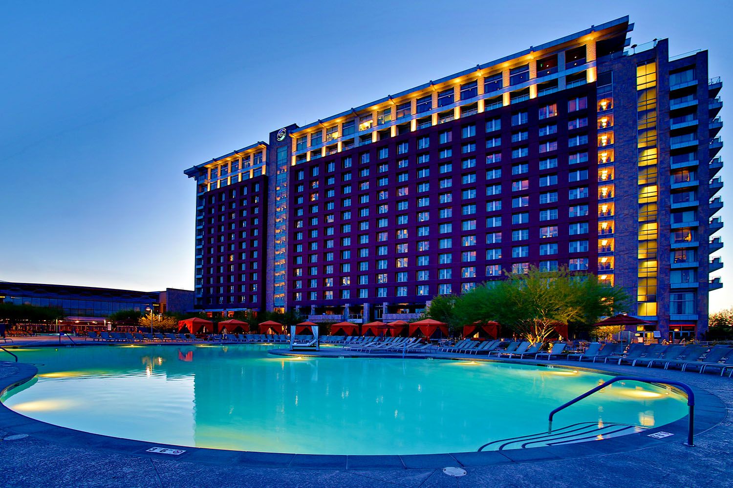 Talking Stick Resort tower above the main pool at twilight